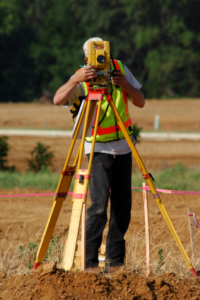 Picture of a Surveyor carrying out a Land Survey, using a Theodolite